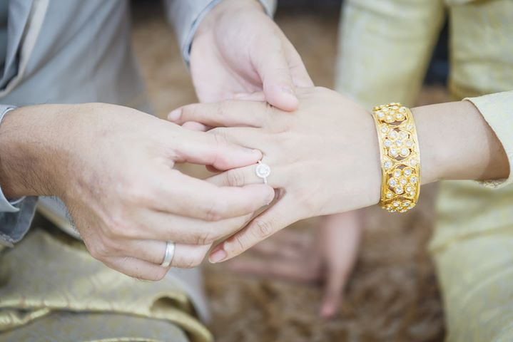 Couple wearing matching silver rings during a wedding ceremony