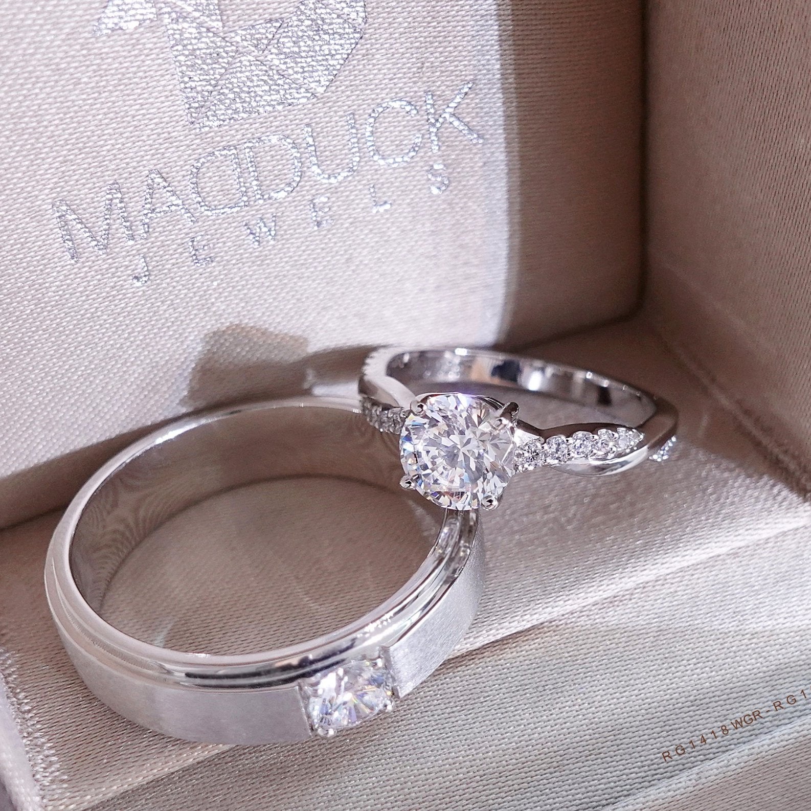 Matching couple rings placed together on soft fabric