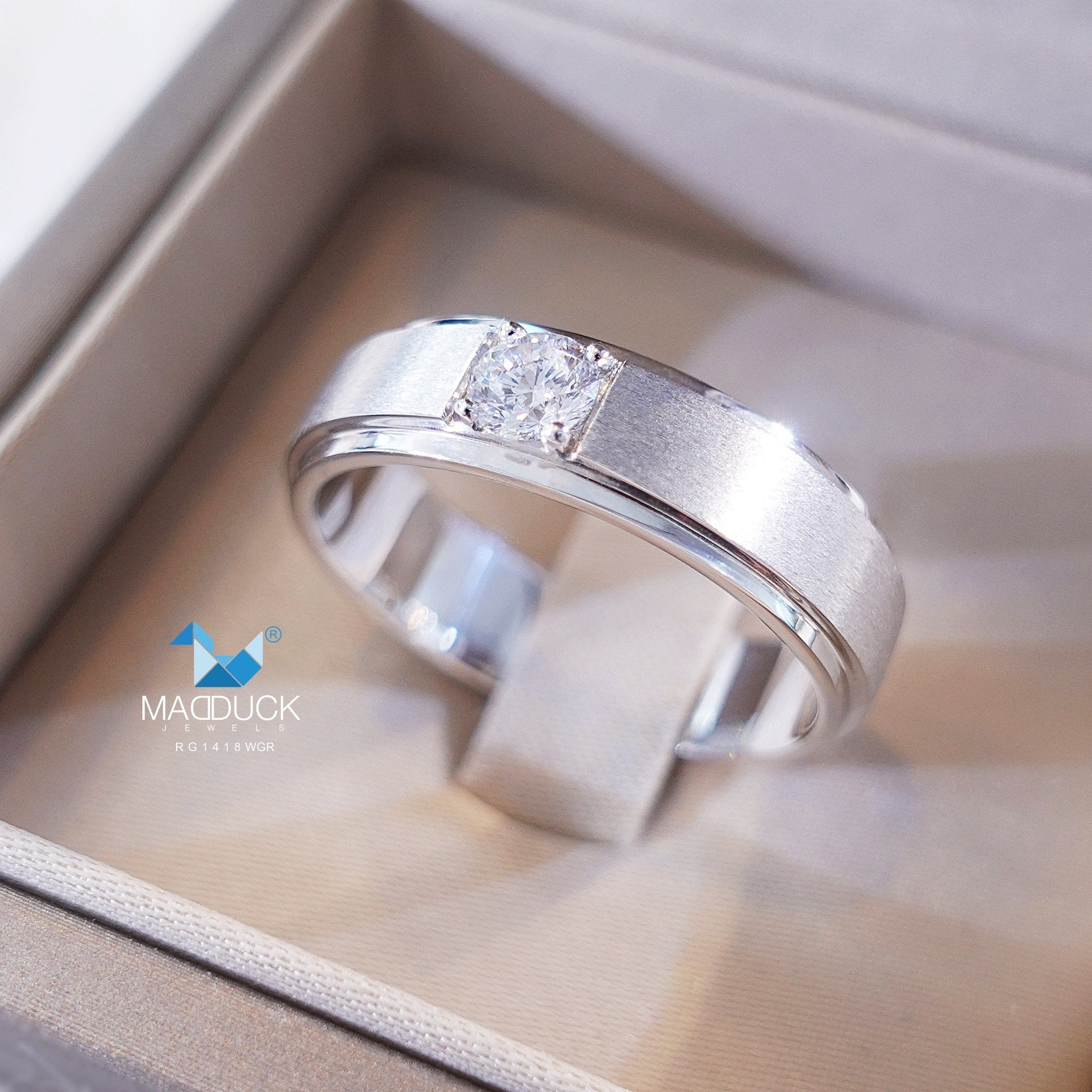 Silver men's ring with bold design on male hand
